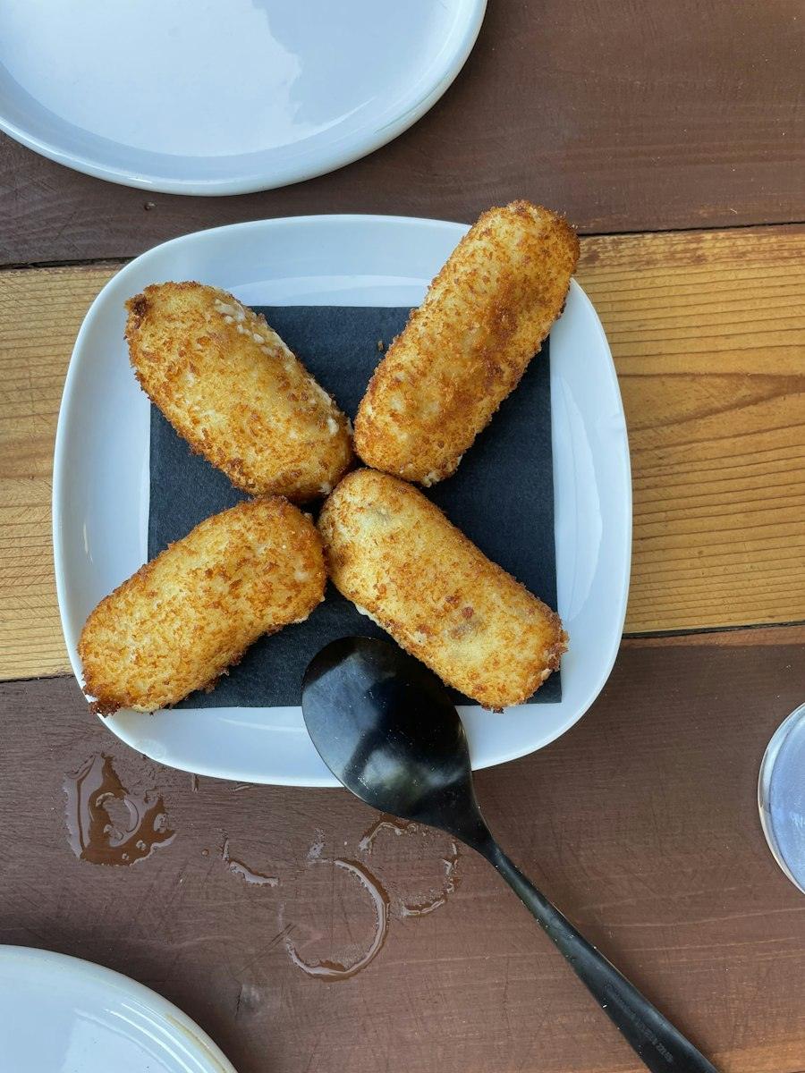 Croquetes daurades en un plat blanc
